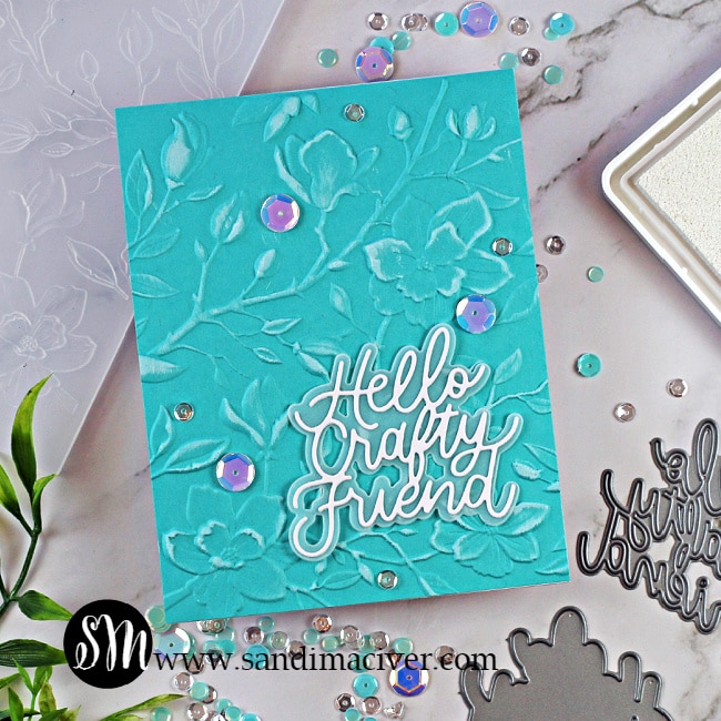 picture of a blue handmade greeting card embossed with the Simon Says Stamp Magnolia