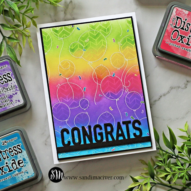  a handmade greeting card colored with distress oxide Inks  in a rainbow pattern and stamped with the Party Balloons stamp from Simon Says Stamp