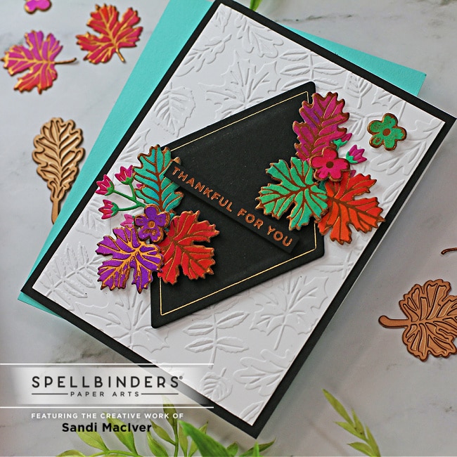 handmade greeting card with fall colored foiled leaves on a white embossed background using card making products from Spellbinders