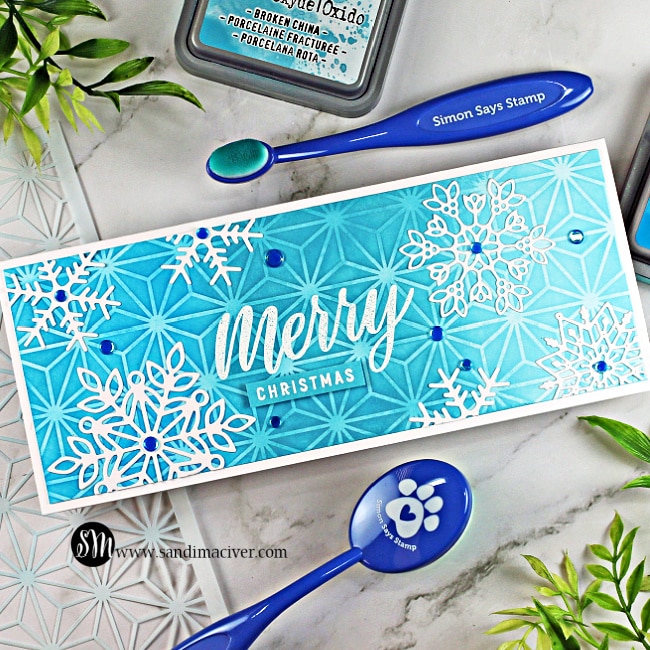 blue stenciled slimline christmas card covered with die cut snowflakes and created using cardmaking and paper crafting products from SImon Says Stamp