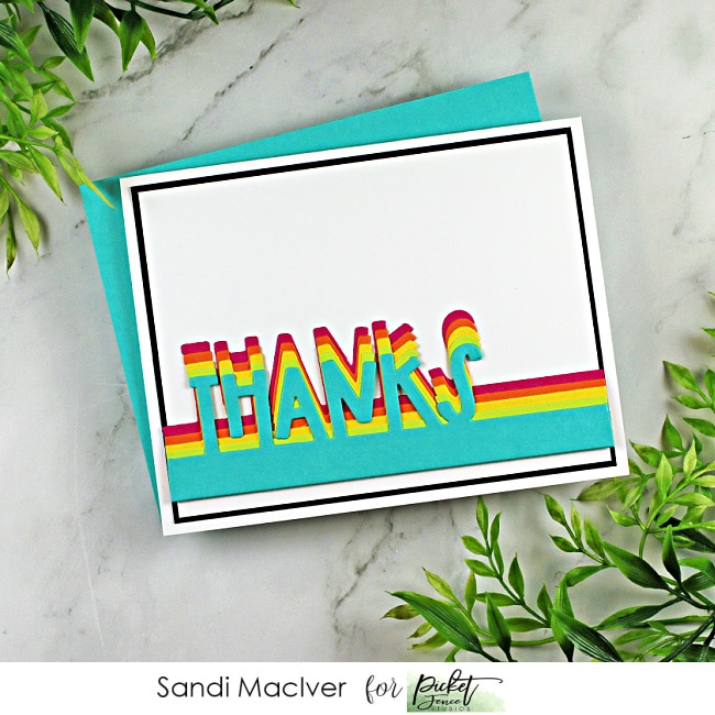 handmade card with a die cut thanks in rainbow colors using cardmaking products from Picket Fence Studios