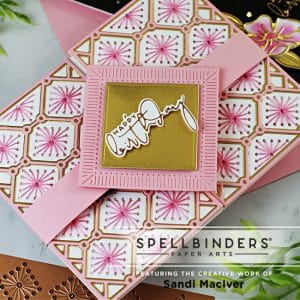 hand stitched card in pink and gold with a center opening and a decorated Belly Band created using paper crafting products from Spellbinders
