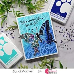 handmade card in light and dark blue with a floral butterfly using cardmaking products from Simon Says Stamp
