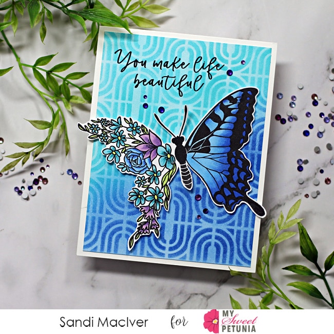 handmade card in light and dark blue with a floral butterfly using cardmaking products from Simon Says Stamp