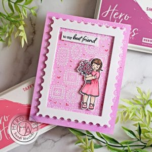 handmade pink valentines card with a little girl holding flowers created with card making supplies from Hero Arts