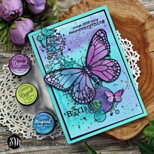 hand made greeting card with a watercolored blue and purple background and a large purple butterfly created with card making products from Lindy's Gang and Visible Image
