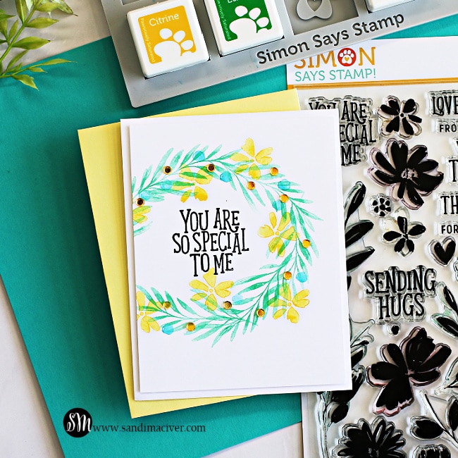 hand made greeting card with a stamped green wreath and yellow flowers using card making supplies from Simon Says Stamp