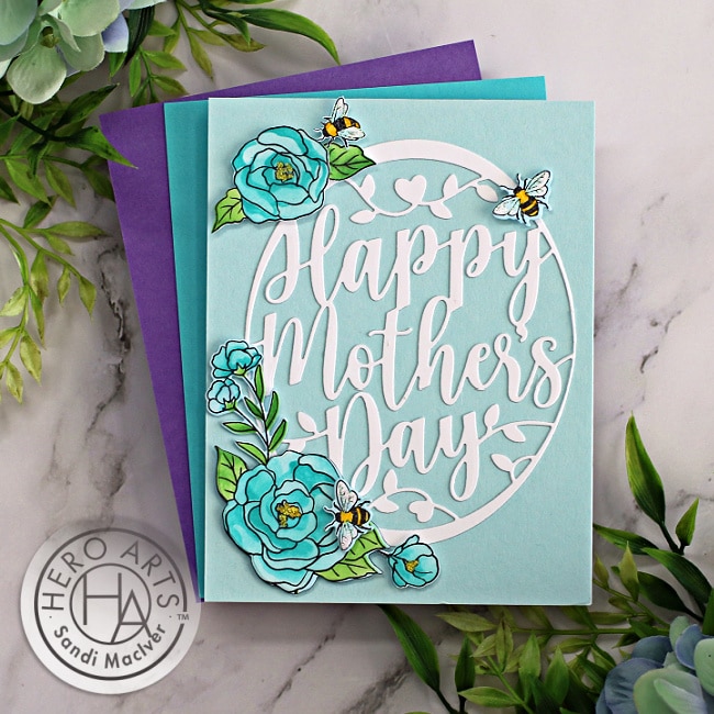 handmade mother's day card in blues and whites with a oval center die cut and flowers and bees using new card making products from Hero Arts