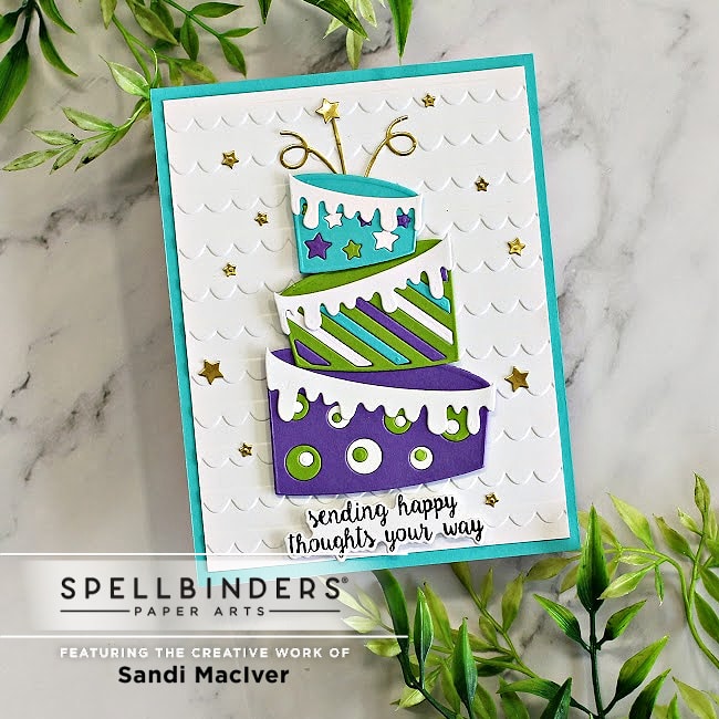 birthday card with a purple green and blue topsy turvy cake created with new card making supplies from Spellbinders