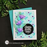 handmade card with a blue and purple stenciled background and purple flowers created with card making supplies from Simon Says Stamp