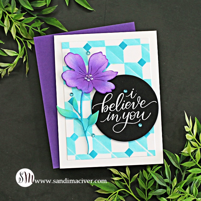 handmade card with a turquoise stenciled background and a large purple flower using card making supplies from Simon Says STamp