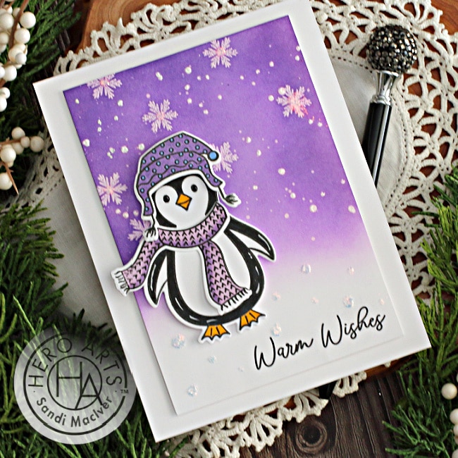 handmade christmas card with a penguin and a purple snowy sky background created with new card making supplies from Hero Arts