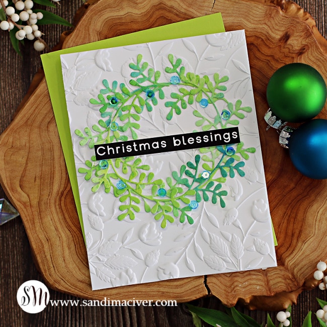 handmade christmas card with a white background and a green die cut wreath using new cardmaking products from Simon Says Stamp