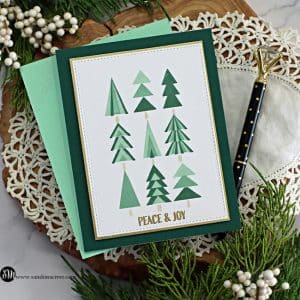 hand made greeting card with little tri colored christmas trees and a pretty stitched edge. created with new card making supplies from Simon Says Stamp