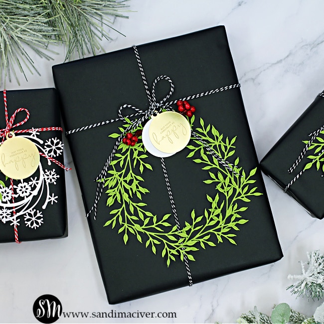 holiday parcel in black with a green die cut wreath and black and white cotton twine