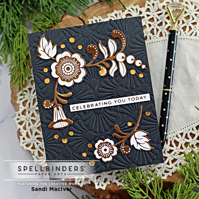 handmade card with a black embossed background and brass colored floral images created with new card making supplies from Spellbinders