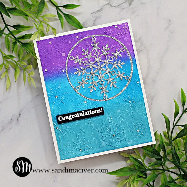 handmade congratulations card with a blue and purple embossed background and a silver die cut snowflake, made with new card making supplies from Simon Says Stamp