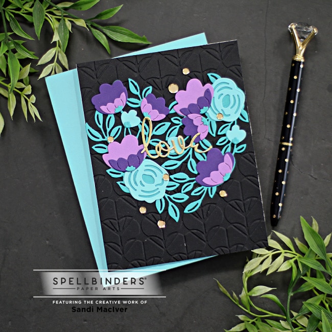 handmade greeting card with a black front and a blue and purple floral heart design created with new card making dies from Spellbinders