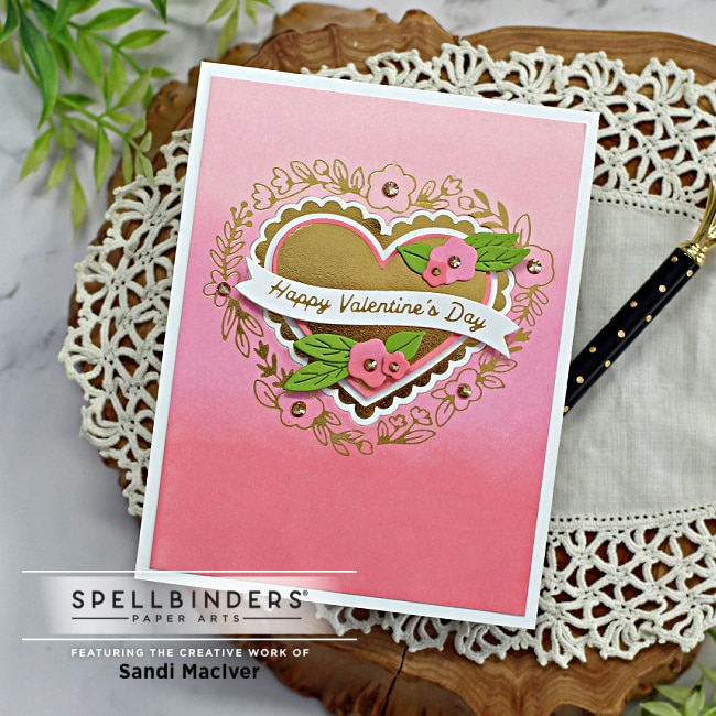 handmade valentine's card with an ombre pink background and gold cut out hearts and flowers created using new card making supplies from Spellbinders
