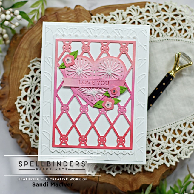 handmade greeting card with a pink stitched heart and flowers created using new card making products from Spellbinders