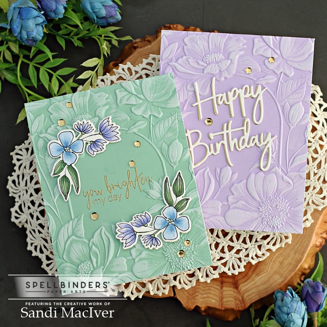 two handmade greeting cards one in green one in purple, with floral designs on them, created with new card making supplies from Spellbinders