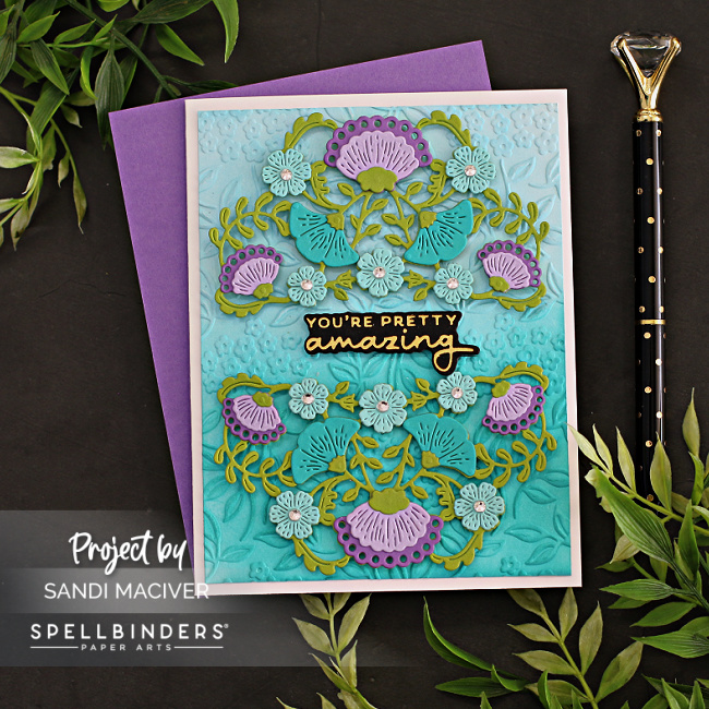 handmade greeting card with purple and teal flowers on an embossed background created with new card making products from Spellbinders