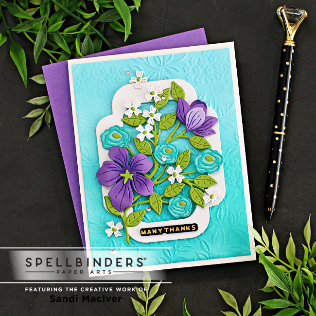handmade greeting card with purple and teal flowers on a teal background created with new card making dies from Spellbinders