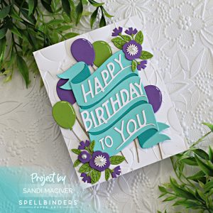 hand made birthday card with a happy birthday banner in teal and purple and green balloons created with new card making supplies from Spellbinders