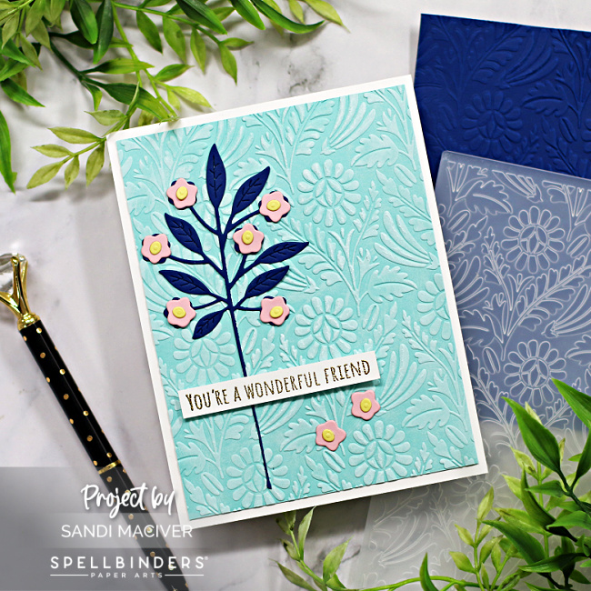 hand made greeting card with a light blue embossed background and dark blue and pink floral overlay created with new card making supplies from Spellbinders