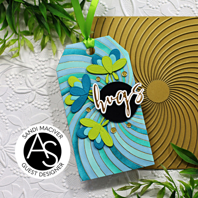 hand made gift take with a blue and green swirl background and overlayed flowers created with new card making products from Alex Syberia Designs