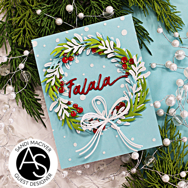 hand made christmas card in blue green red and white with a die cut wreath created with new card making supplies from Alex Syberia Designs