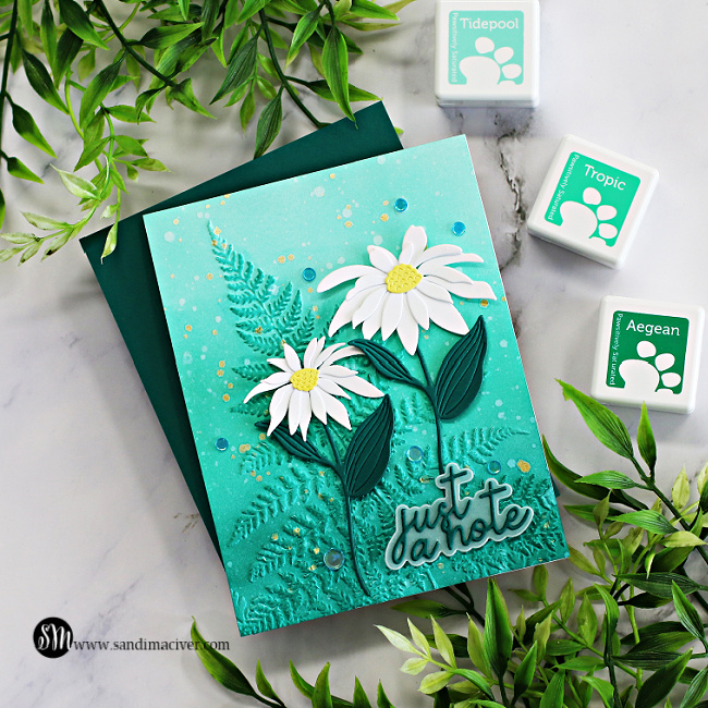hand made greeting card with a blue green embossed background and white daisies created with new card making supplies from Simon Says Stamp