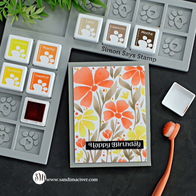 Hand made card with a stenciled floral image in browns, oranges and yellows using new card making supplies from SImon Says Stamp