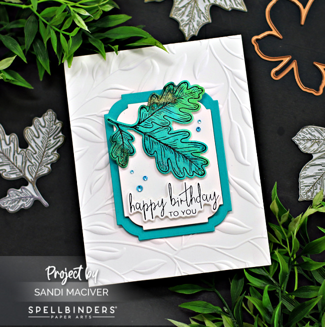 hand made fall card with tteal leaves on a embossed white background created with new card making products from Spellbinders
