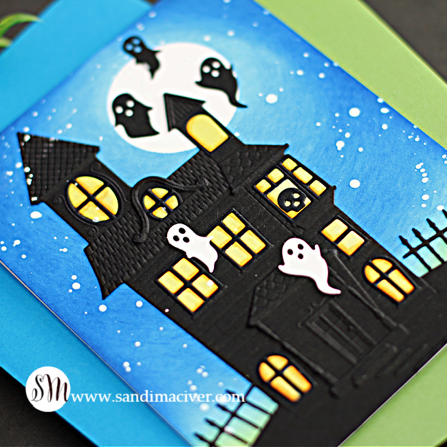 halloween card with a blue sky, white moon and black haunted house with ghosts created with new card making products from Simon Says Stamp