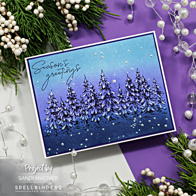 purple and blue christmas card with a row of evergreens created with betterpress products from Spellbinders