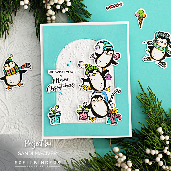 hand made christmas card with a stack of adorable penguins and gifts created with new card making supplies from Spellbinders