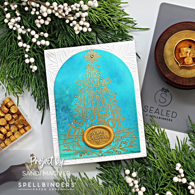 blue watercolor christmas card with a gold embossed tree created with card making supplies from Spellbinders