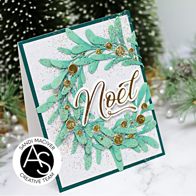 hand made christmas card with a die cut wreath and gold highlights created with new card making products from Alex Syberia Designs