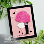 hand made valentines card with a couple kissing under an umbrella created with card making supplies from Spellbinders