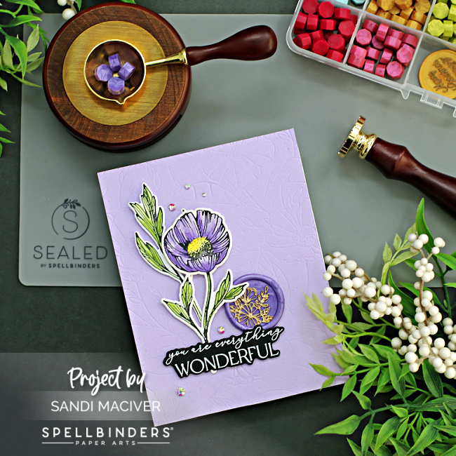 Purple card with a purple flower and a purple wax seal created with new card making supplies from Spellbinders