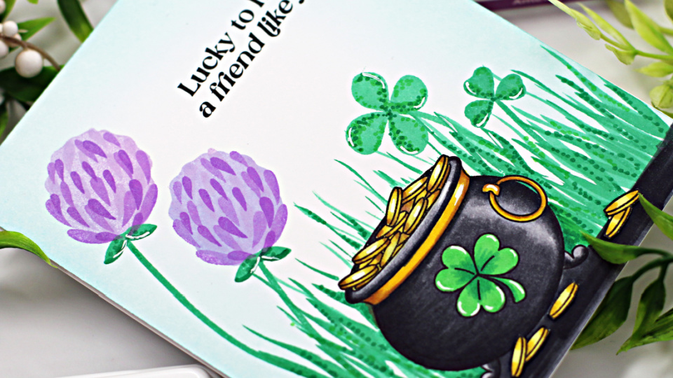 hand made card with a black pot of gold full of gold coins, sitting amongst grass and clover, including a 4 leaf clover, created with new card making supplies from Simon Says sTamp