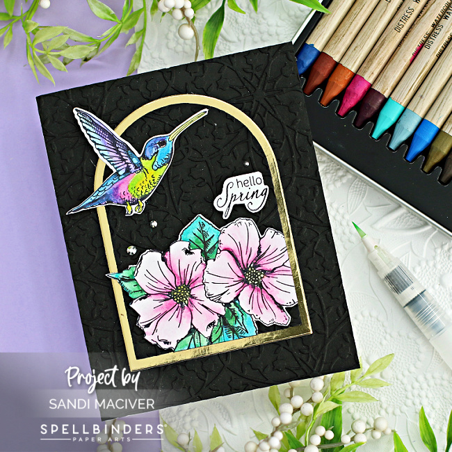 watercolored pink flowers and a green and pink hummingbird on a hand made card created with new card making supplies from Spellbinders