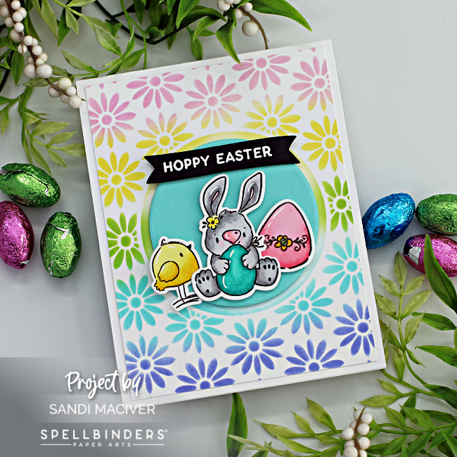 hand made Easter card with a ink blended rainbow background and a bunny chick and egg in the center created with new card making products from Spellbinders 