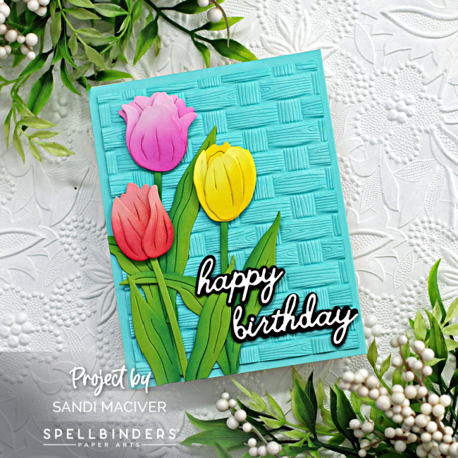 hand made birthday card with a blue basket embossed background and three die cut tulips, created with new card making supplies from Spellbinders