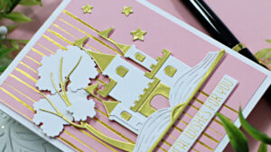 handmade card with a white and gold castle and a pink background created with new card making products from Spellbinders