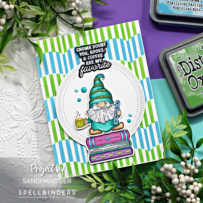 hand made greeting card with a colorful gnome standing on a stack of books created with new card making products from Spellbinders