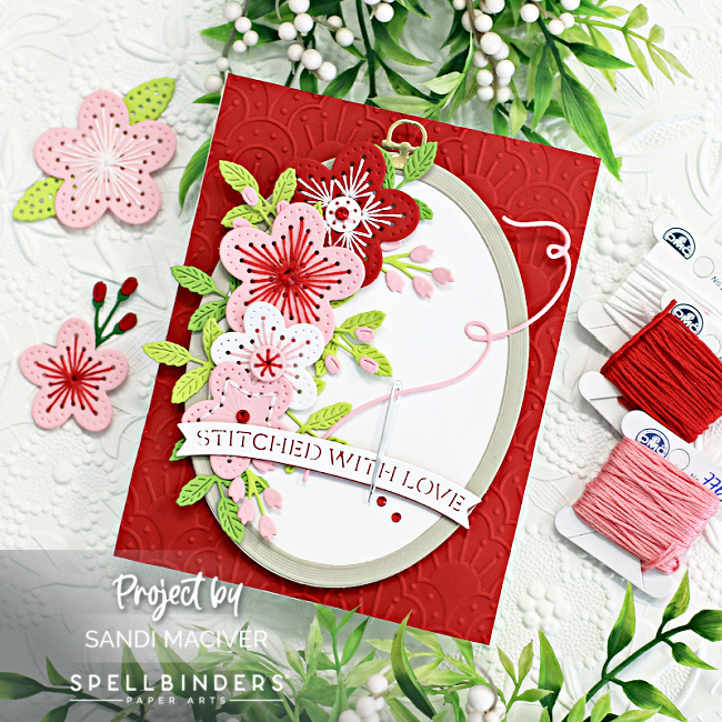 red pink and white hand made greeting card with stitched flowers and a wood looking embossing ring created with new card making supplies from SPellbinders