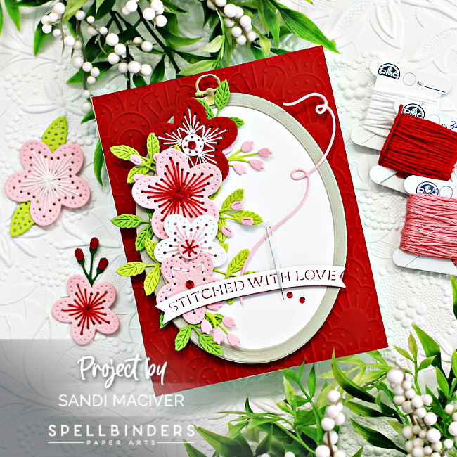 red pink and white hand made greeting card with stitched flowers and a wood looking embossing ring created with new card making supplies from SPellbinders