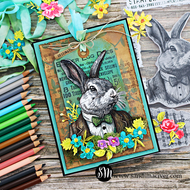 Mixed media easter card in blues, greens and browns with a vintage rabbit dressed in a suit, decorated with moss and flowers created with new card making products from simon Says Stamp